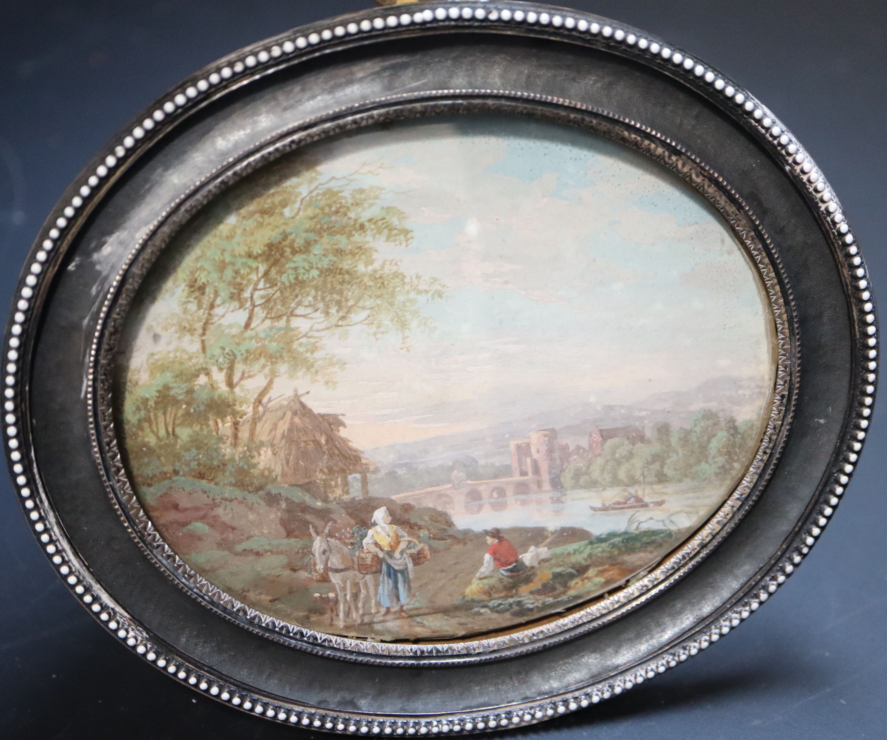 Style of Zuccarelli, Travellers in an Italianate landscape 9 x 11cm white enamel beaded decoration and gilt metal back overall 12.5 x 1